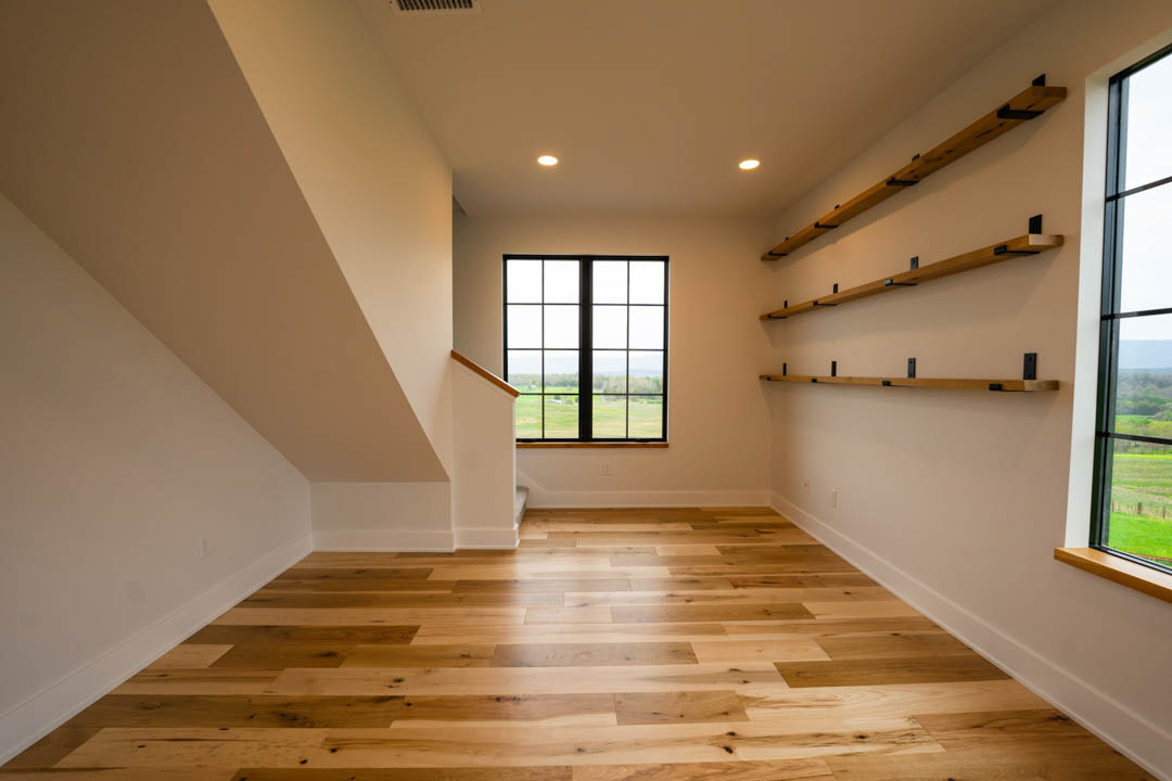 room with built-in wooden shelves hill top house