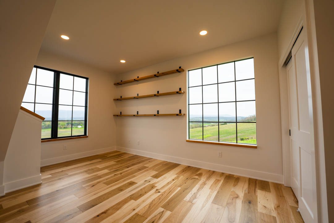 room with built-in wooden shelves hill top house