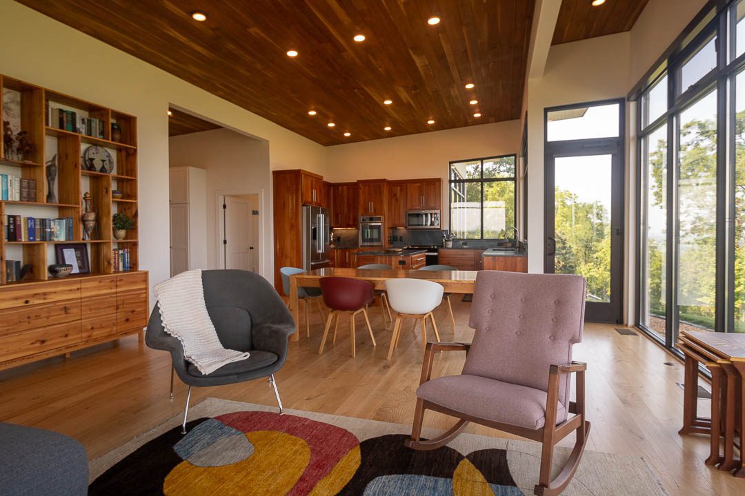 wide view of the house open space with a portion of the living room, dining table, and kitchen showing.