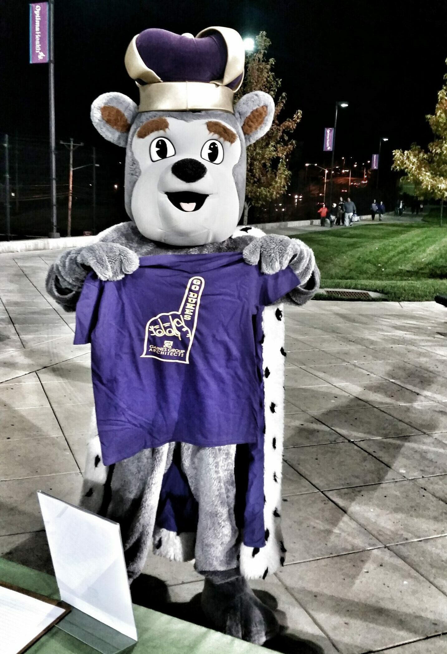 Duke dog holding gaines group t-shirt.
