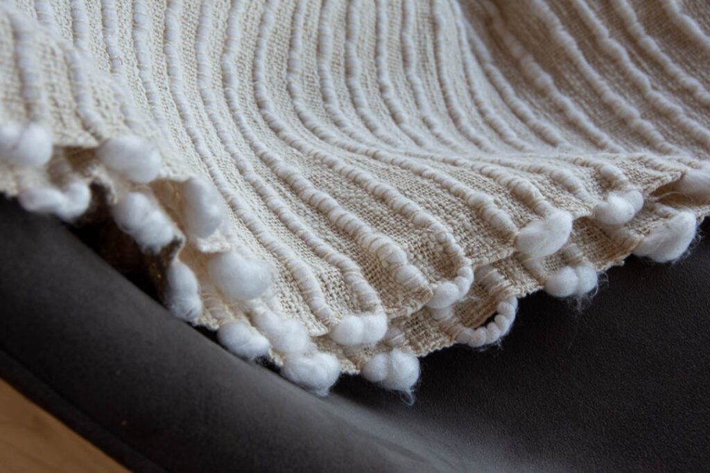 Soft blanket draped across a chair.