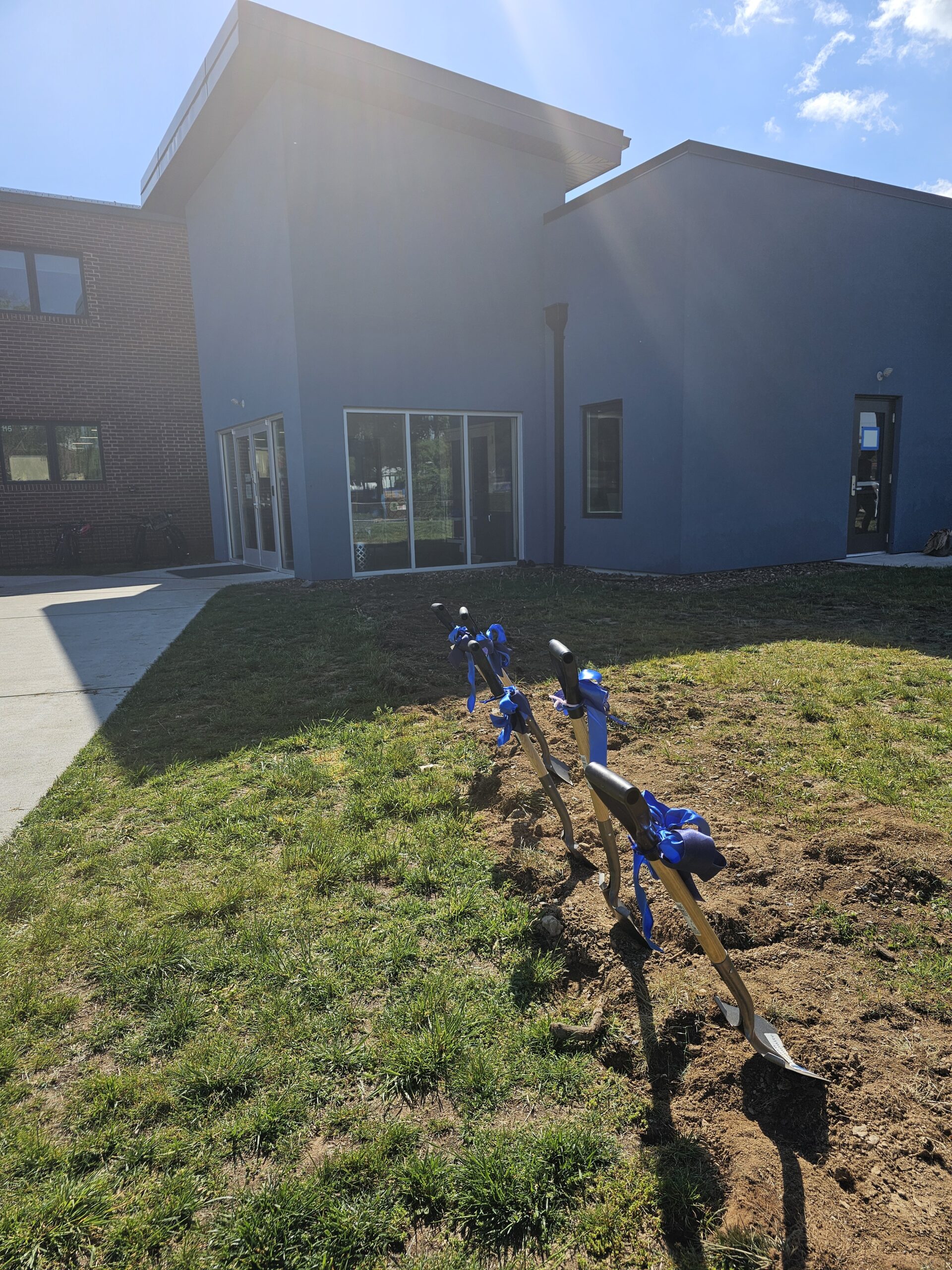 Shovels in the soil with blue ribbons for the ground breaking ceremony at Eastern Mennonite Elementary School.